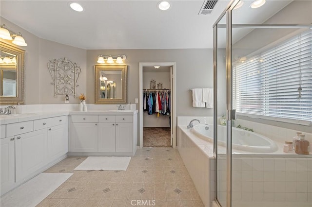 30336 Barcelona Rd, Castaic, CA 91384 - full bath featuring double vanity, a garden tub, tile patterned flooring, recessed lighting, and a shower stall