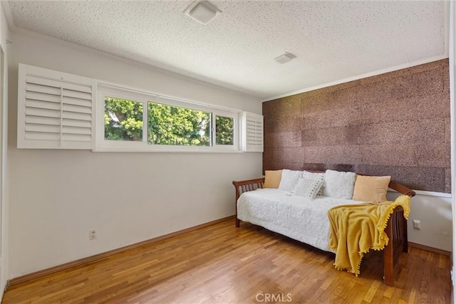 2012 Perry Ave, Redondo Beach, CA 90278 - bedroom with a textured ceiling, wood finished floors, an accent wall, and crown molding