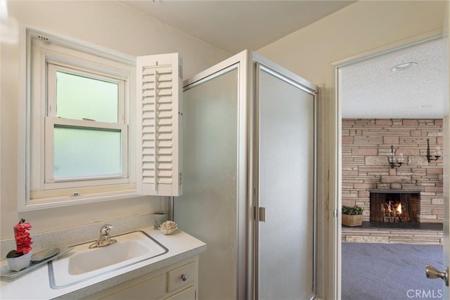 2012 Perry Ave, Redondo Beach, CA 90278 - full bath featuring vanity, a shower stall, a stone fireplace, and a textured ceiling