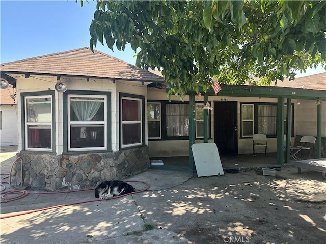 12465 Fineview St, El Monte, CA 91732 - back of house with a patio, roof with shingles, and stone siding