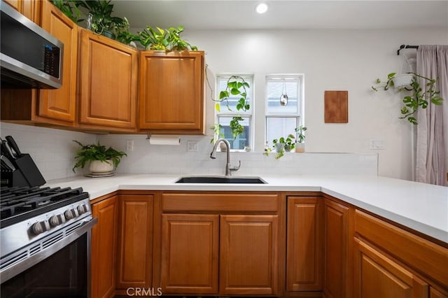 2848 S Kerckhoff Ave, San Pedro, CA 90731 - kitchen with stainless steel appliances, decorative backsplash, light countertops, recessed lighting, and brown cabinets