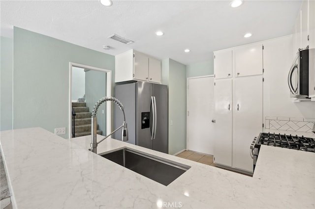 19659 Monteano Ln, Yorba Linda, CA 92886 - kitchen featuring appliances with stainless steel finishes, light stone countertops, white cabinetry, and recessed lighting