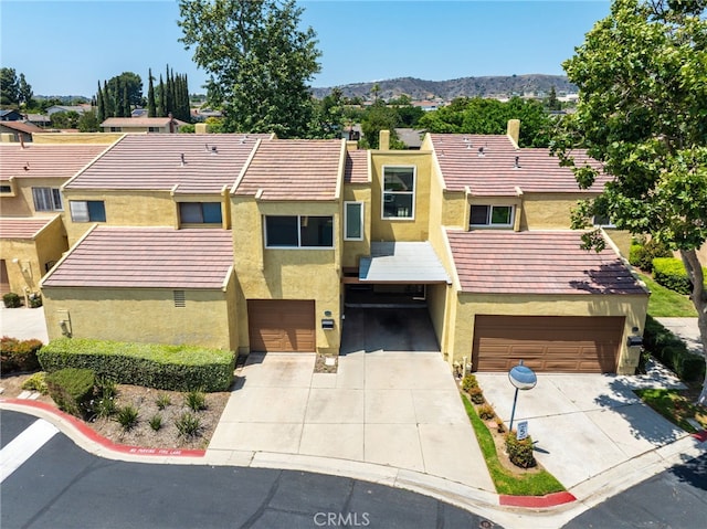 19659 Monteano Ln, Yorba Linda, CA 92886 - townhome / multi-family property with an attached garage, driveway, stucco siding, and a mountain view