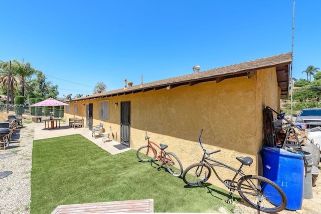 6743 Radio Dr, San Diego, CA 92114 - rear view of house featuring stucco siding and a patio