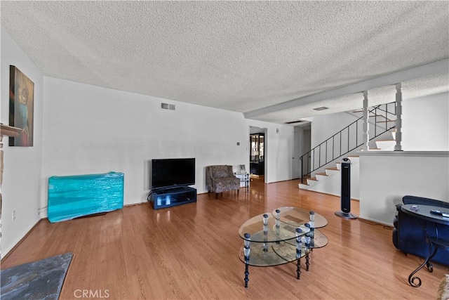 10415 Valley View Ave, Whittier, CA 90604 - living area with a textured ceiling, wood finished floors, and stairs