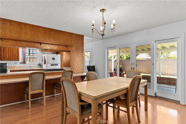 10415 Valley View Ave, Whittier, CA 90604 - dining room featuring light wood-type flooring, a chandelier, and a textured ceiling