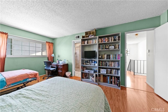 10415 Valley View Ave, Whittier, CA 90604 - bedroom featuring a textured ceiling, wood finished floors, and multiple windows
