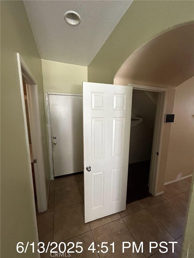 6921 Montego St, Chino, CA 91710 - hallway with tile patterned floors and arched walkways