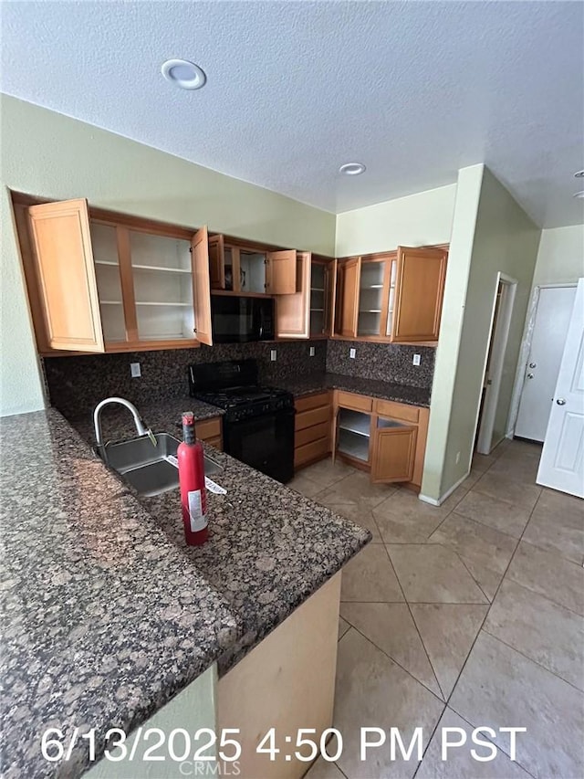 6921 Montego St, Chino, CA 91710 - kitchen featuring black appliances, open shelves, tasteful backsplash, a peninsula, and dark stone countertops