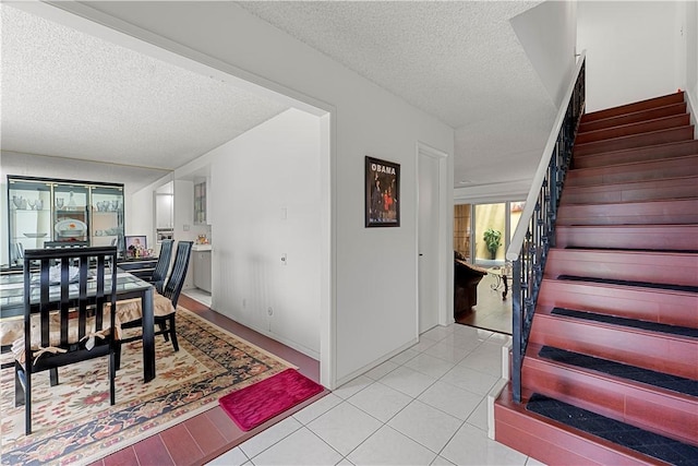 3500 W Manchester Blvd Unit 240, Inglewood, CA 90305 - dining area featuring stairs, a textured ceiling, and light tile patterned flooring