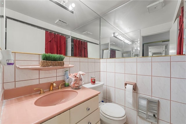 3500 W Manchester Blvd Unit 240, Inglewood, CA 90305 - bathroom with tile walls, vanity, a shower with shower curtain, heating unit, and decorative backsplash