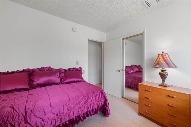 3500 W Manchester Blvd Unit 240, Inglewood, CA 90305 - bedroom featuring light colored carpet, a textured ceiling, and a closet