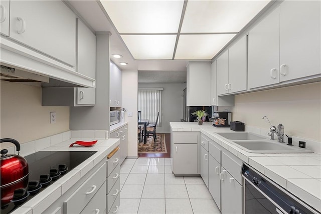 3500 W Manchester Blvd Unit 240, Inglewood, CA 90305 - kitchen featuring dishwasher, black electric cooktop, light tile patterned floors, and tile counters