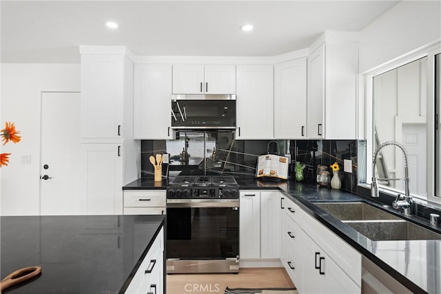 8771 La Grand Ave, Garden Grove, CA 92841 - kitchen featuring stainless steel appliances, white cabinets, tasteful backsplash, recessed lighting, and dark stone counters
