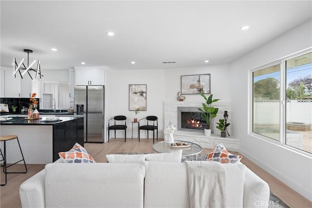 8771 La Grand Ave, Garden Grove, CA 92841 - living room with recessed lighting, light wood-type flooring, and a glass covered fireplace