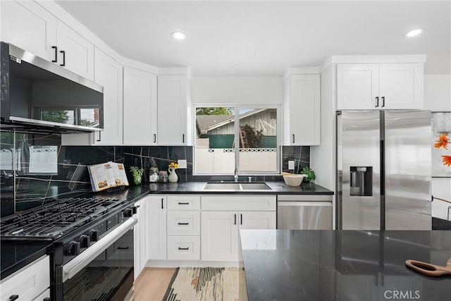 8771 La Grand Ave, Garden Grove, CA 92841 - kitchen with appliances with stainless steel finishes, dark countertops, white cabinetry, decorative backsplash, and recessed lighting