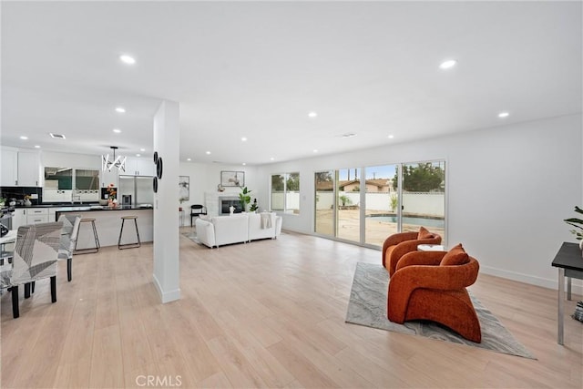 8771 La Grand Ave, Garden Grove, CA 92841 - living area with recessed lighting, light wood-type flooring, a chandelier, and a fireplace