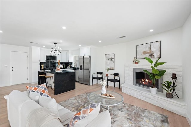 8771 La Grand Ave, Garden Grove, CA 92841 - living area featuring a fireplace, light wood finished floors, and recessed lighting