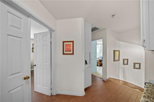 1142 Daisy Cir, Corona, CA 92882 - hallway featuring dark wood-type flooring and baseboards