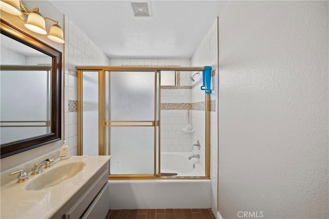 1142 Daisy Cir, Corona, CA 92882 - bathroom with vanity, combined bath / shower with glass door, and a textured ceiling