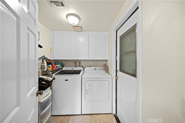 1142 Daisy Cir, Corona, CA 92882 - washroom featuring cabinet space, washer and dryer, and light tile patterned floors