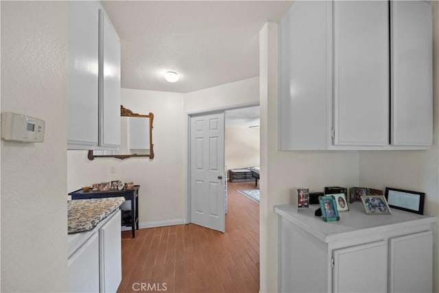 1142 Daisy Cir, Corona, CA 92882 - kitchen with light countertops, light wood-type flooring, and white cabinetry