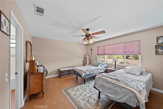 1142 Daisy Cir, Corona, CA 92882 - bedroom with wood finished floors, a ceiling fan, and a textured ceiling