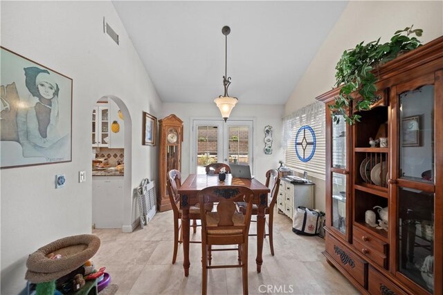 1142 Daisy Cir, Corona, CA 92882 - dining room featuring arched walkways, french doors, and high vaulted ceiling