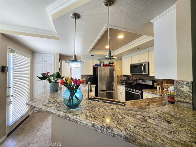 25632 Salerno Way, Yorba Linda, CA 92887 - kitchen with appliances with stainless steel finishes, crown molding, decorative backsplash, light stone countertops, and a tray ceiling