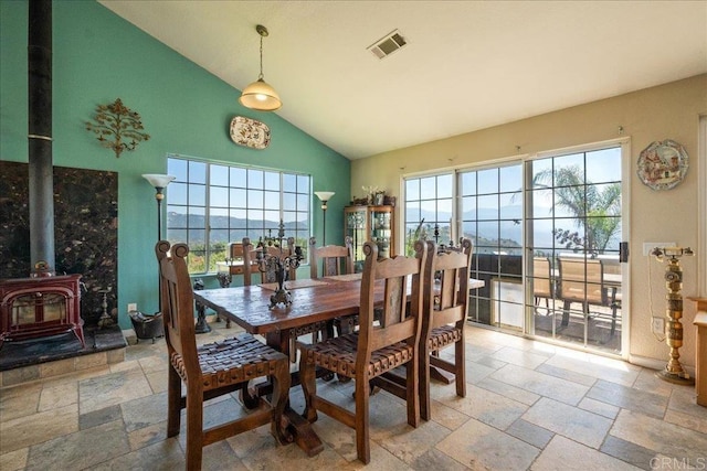 772 Rainbow Crest Rd, Fallbrook, CA 92028 - dining space featuring stone tile flooring, a wood stove, and high vaulted ceiling