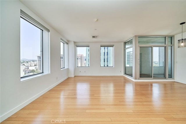 3810 Wilshire Blvd Unit 805, Los Angeles, CA 90010 - empty room with healthy amount of natural light, light wood-style flooring, and a smoke detector