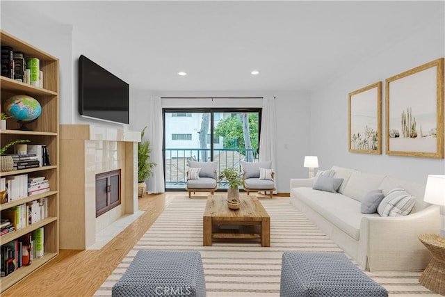 7505 Hampton Ave Unit 8, West Hollywood, CA 90046 - living room with light wood-type flooring, a fireplace, and recessed lighting