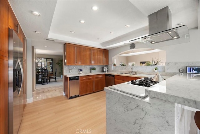 12281 Alta Panorama, North Tustin, CA 92705 - kitchen featuring appliances with stainless steel finishes, brown cabinets, light wood-style flooring, backsplash, and recessed lighting