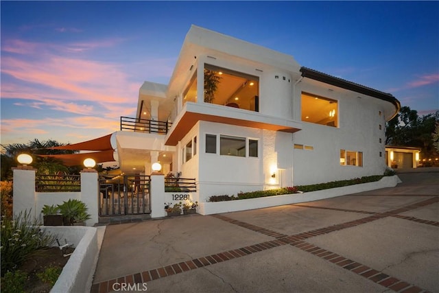 12281 Alta Panorama, North Tustin, CA 92705 - contemporary house featuring a balcony, a fenced front yard, and stucco siding