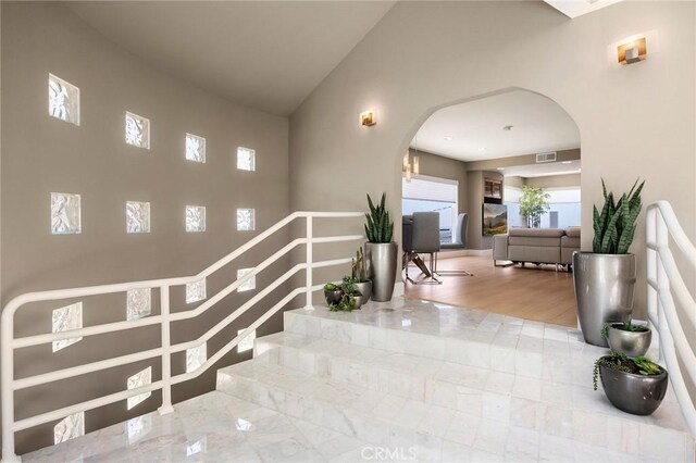 12281 Alta Panorama, North Tustin, CA 92705 - stairway with arched walkways, wood finished floors, and a towering ceiling