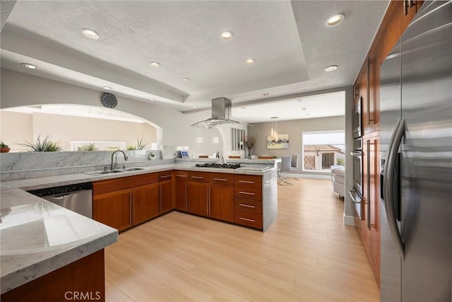 12281 Alta Panorama, North Tustin, CA 92705 - kitchen with appliances with stainless steel finishes, a tray ceiling, brown cabinets, a peninsula, and a warming drawer