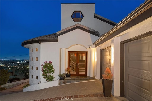 12281 Alta Panorama, North Tustin, CA 92705 - exterior entry at night with stucco siding and a tile roof