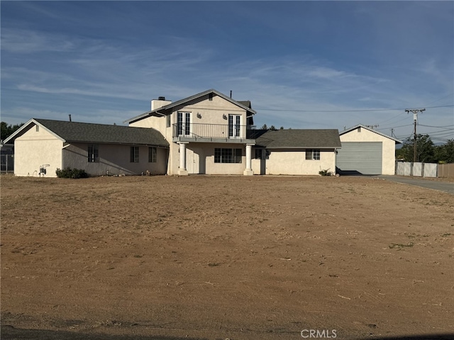 20635 Tonawanda Rd, Apple Valley, CA 92307 - back of house with a balcony, stucco siding, and a garage