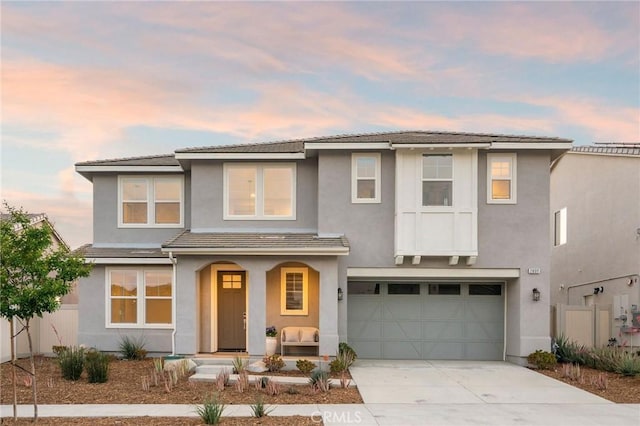 28511 Sparrow Way, Saugus, CA 91350 - view of front of home with a porch, stucco siding, concrete driveway, a garage, and a tiled roof