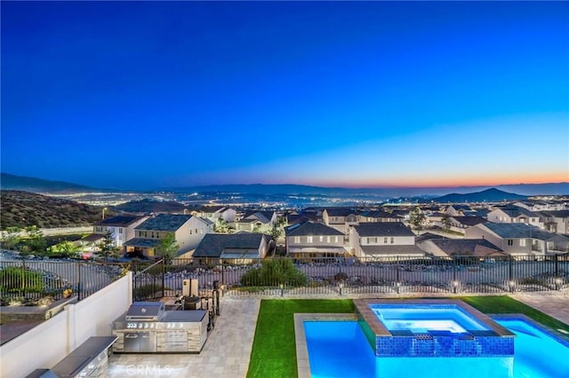 28511 Sparrow Way, Saugus, CA 91350 - pool at dusk with area for grilling, a fenced backyard, a residential view, a patio, and a pool with connected hot tub
