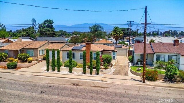2685 Arrow Hwy, La Verne, CA 91750 - ranch-style home with a residential view, a garage, and solar panels