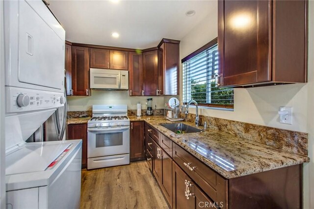 2685 Arrow Hwy, La Verne, CA 91750 - kitchen with white appliances, stacked washer and clothes dryer, light wood-type flooring, light stone countertops, and recessed lighting