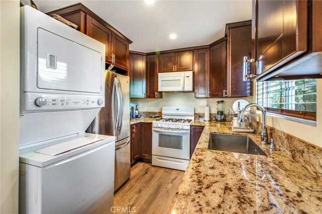 2685 Arrow Hwy, La Verne, CA 91750 - kitchen featuring white appliances, stacked washing machine and dryer, light stone countertops, light wood-style flooring, and recessed lighting