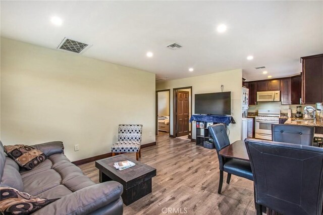 2685 Arrow Hwy, La Verne, CA 91750 - living room with recessed lighting and light wood-style floors