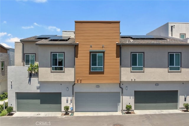 1060 Kendale Way, Vista, CA 92081 - view of front of home with an attached garage, solar panels, and stucco siding
