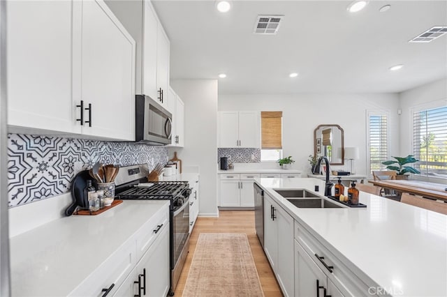 1060 Kendale Way, Vista, CA 92081 - kitchen featuring stainless steel appliances, light countertops, recessed lighting, light wood-type flooring, and white cabinetry