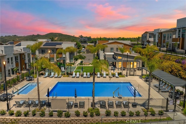 1060 Kendale Way, Vista, CA 92081 - pool at dusk featuring a community pool, a residential view, and a patio
