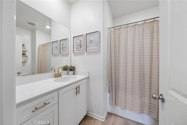 1060 Kendale Way, Vista, CA 92081 - bathroom with vanity, wood finished floors, and shower / bath combination with curtain