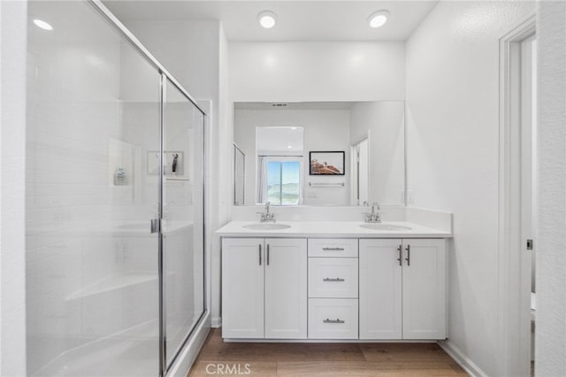 1060 Kendale Way, Vista, CA 92081 - bathroom with double vanity, a shower stall, and wood finished floors