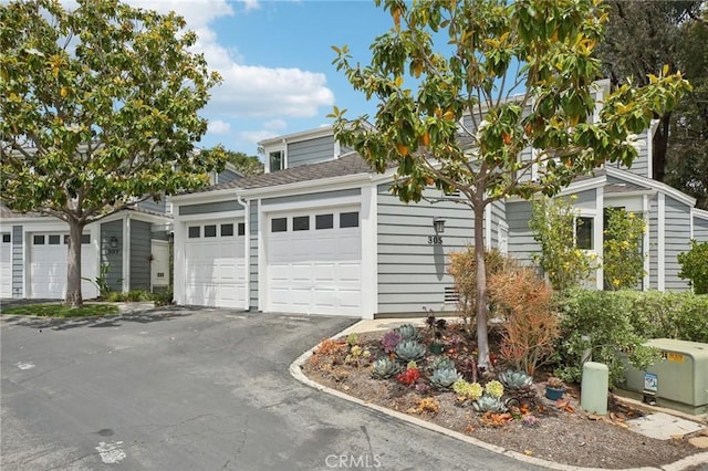 306 San Nicholas Ct, Laguna Beach, CA 92651 - view of front facade featuring asphalt driveway, a garage, and a shingled roof